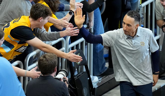 Marquette head coach Shaka Smart celebrates his team’s win with the student section after their game Wednesday, December 6, 2023 at Fiserv Forum in Milwaukee, Wisconsin. Marquette beat Texas 86-65.