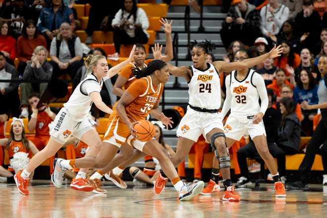 Jan 20, 2024; Stillwater, Okla, USA; Texas Longhorns forward Madison Booker (35) drives past Oklahoma State Cowgirls guard Anna Gret Asi (4) and forward Praise Egharevba (24) in the first half of a womenÕs NCAA basketball game at Gallagher Iba Arena.