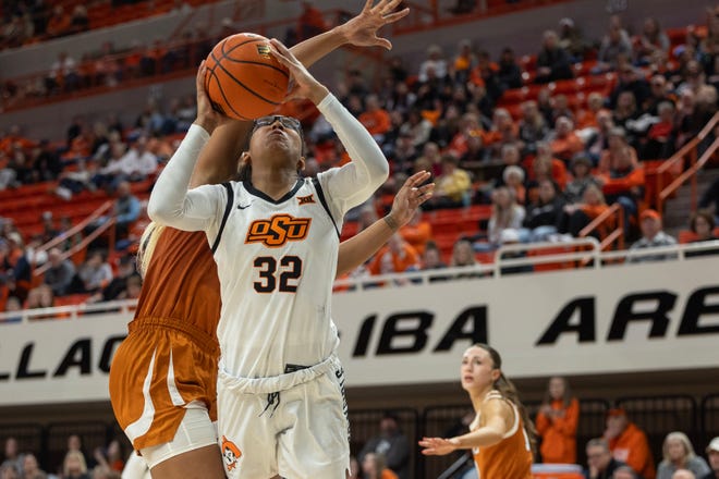Jan 20, 2024; Stillwater, Okla, USA; Texas Longhorns forward Aaliyah Moore (23) fouls Oklahoma State Cowgirls guard Stailee Heard (32) in the second half of a womenÕs NCAA basketball game at Gallagher Iba Arena. Mandatory Credit: Mitch Alcala-The Oklahoman. Mandatory Credit: Mitch Alcala-The Oklahoman