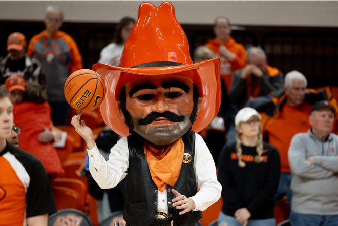 Jan 20, 2024; Stillwater, Okla, USA; Oklahoma State Mascot, Pistol Pete, plays with a basketball after a womenÕs NCAA basketball game against the Texas Longhorns at Gallagher Iba Arena. Mandatory Credit: Mitch Alcala-The Oklahoman. Mandatory Credit: Mitch Alcala-The Oklahoman