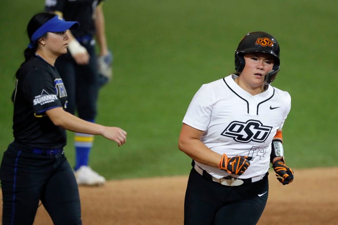 Oklahoma State infielder Karli Godwin (14) runs home after hitting a home run in the sixth inning of a college softball game between the Oklahoma State University Cowgirls and the South Dakota State Jackrabbits, Tuesday, Feb. 27, 2024.