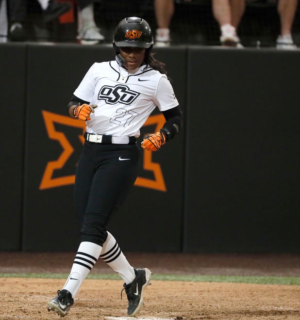 Oklahoma State's Jilyen Poullard (27) scores a tun in the sixth inning of a college softball game between the Oklahoma State University Cowgirls and the South Dakota State Jackrabbits, Tuesday, Feb. 27, 2024.