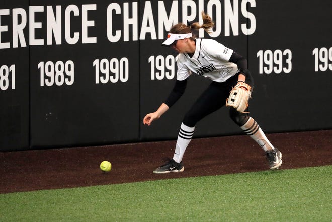 Oklahoma State outfielder Haidyn Sokoloski (21) chases down the ball during a college softball game between the Oklahoma State University Cowgirls and the South Dakota State Jackrabbits, Tuesday, Feb. 27, 2024.