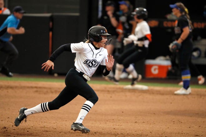 Oklahoma State's Taylor Anderson (5) runs to third base in the fifth inning of a college softball game between the Oklahoma State University Cowgirls and the South Dakota State Jackrabbits, Tuesday, Feb. 27, 2024.