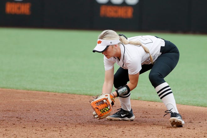 Oklahoma State infielder Rosie Davis (26) fields the ball during a college softball game between the Oklahoma State University Cowgirls and the South Dakota State Jackrabbits, Tuesday, Feb. 27, 2024.