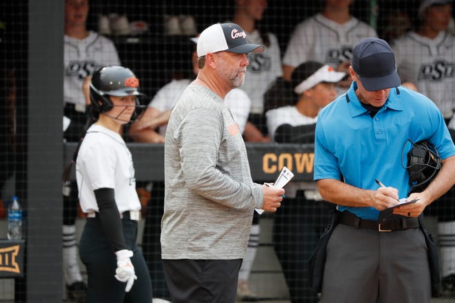 Oklahoma State coach Kenny Gajewski talks with an official during a college softball game between the Oklahoma State University Cowgirls and the South Dakota State Jackrabbits, Tuesday, Feb. 27, 2024.