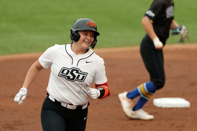 Oklahoma State infielder Micaela Wark (12) smilkes after hitting a home run during a college softball game between the Oklahoma State University Cowgirls and the South Dakota State Jackrabbits, Tuesday, Feb. 27, 2024.