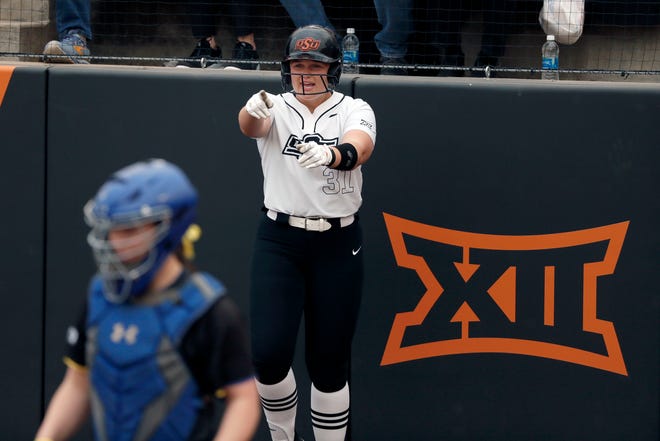Oklahoma State infielder Lexi McDonald (31) celebrates after scoring a run during a college softball game between the Oklahoma State University Cowgirls and the South Dakota State Jackrabbits, Tuesday, Feb. 27, 2024.