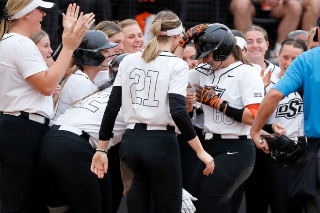 Oklahoma State catcher Caroline Wang (66) celebrates with teammates after hitting a home run during a college softball game between the Oklahoma State University Cowgirls and the South Dakota State Jackrabbits, Tuesday, Feb. 27, 2024.