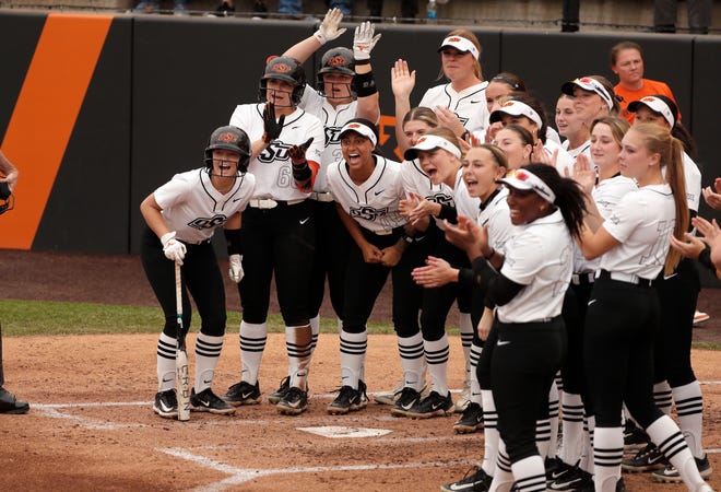Oklahoma State players celebrate after a home run during a college softball game between the Oklahoma State University Cowgirls and the South Dakota State Jackrabbits, Tuesday, Feb. 27, 2024.