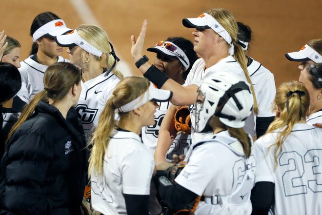 Oklahoma State's Lexi Kilfoyl (8) slaps hands with teammates after an inning in the second softball game of a double header between the Oklahoma State University Cowgirls and the South Dakota State Jackrabbits, Tuesday, Feb. 27, 2024.