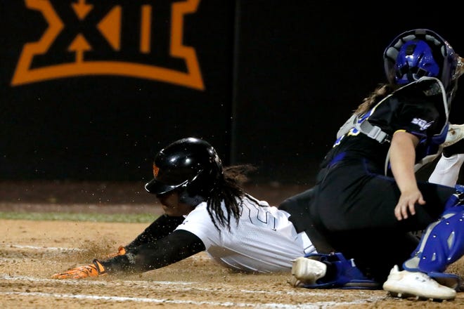 Oklahoma State's Jilyen Poullard (27) slides home to score a run past South Dakota State's Abby Gentry (24) in the second softball game of a double header between the Oklahoma State University Cowgirls and the South Dakota State Jackrabbits, Tuesday, Feb. 27, 2024.