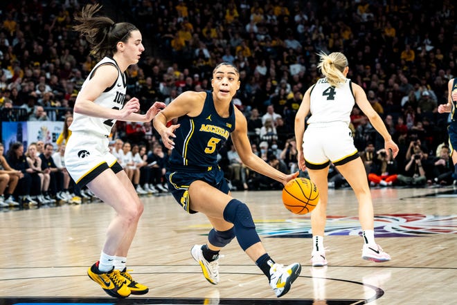 Michigan guard Laila Phelia drives to the basket against Iowa's Caitlin Clark during their Big Ten Tournament semifinal game on March 9. Phelia, who earned first-team all-conference honors after averaging 16.8 points a game, has transferred to Texas.