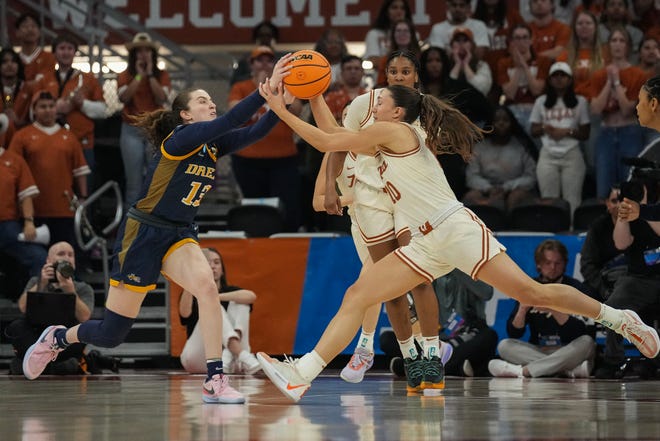 Texas Longhorns guard Shay Holle (10) and Drexel Dragons guard Erin Sweeney (13) fight for the ball as Texas takes on the Drexel Dragons in round one of the NCAA women's basketball tournament at the Moody Center in Austin Friday, March 22, 2024.