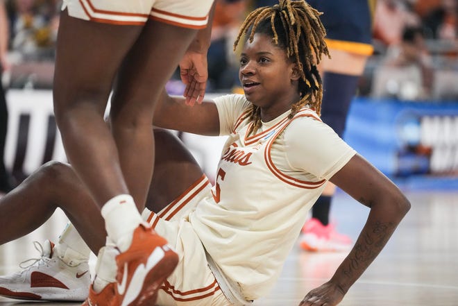 Texas Longhorns forward DeYona Gaston (5) is helped up following a foul as Texas takes on the Drexel Dragons in round one of the NCAA women's basketball tournament at the Moody Center in Austin Friday, March 22, 2024.