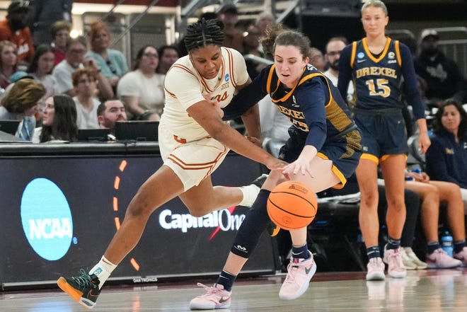 Texas Longhorns forward Madison Booker (35) and Drexel Dragons guard Erin Sweeney (13) fight for control of the ball as Texas takes on the Drexel Dragons in round one of the NCAA women's basketball tournament at the Moody Center in Austin Friday, March 22, 2024.