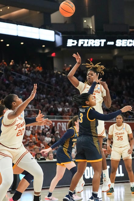 Texas Longhorns forward DeYona Gaston (5) passes to Texas Longhorns forward Khadija Faye (20) as Texas takes on the Drexel Dragons in round one of the NCAA women's basketball tournament at the Moody Center in Austin Friday, March 22, 2024.