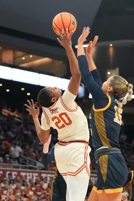 Texas Longhorns forward Khadija Faye (20) and Drexel Dragons guard Brooke Mullin (15) reach for the ball as Texas takes on the Drexel Dragons in round one of the NCAA women's basketball tournament at the Moody Center in Austin Friday, March 22, 2024.