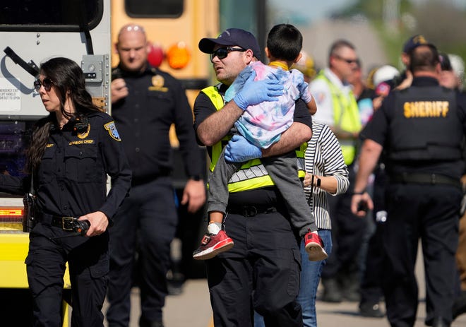 A boy is comforted while he is being transported from a fatal school bus crash on SH 21 near Caldwell Road Friday March 22, 2024.

Editor's note: The Austin American-Statesman is publishing photos of first responders and children following the school bus crash after careful consideration to document the breaking news and public safety nature of the incident.