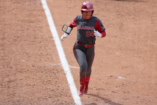 Oklahoma's Jayda Coleman (24) runs home to score a run in the fourth inning of a college softball game between the University of Oklahoma Sooners (OU) and the Baylor Bears in Norman, Okla., Saturday, March 23, 2024.