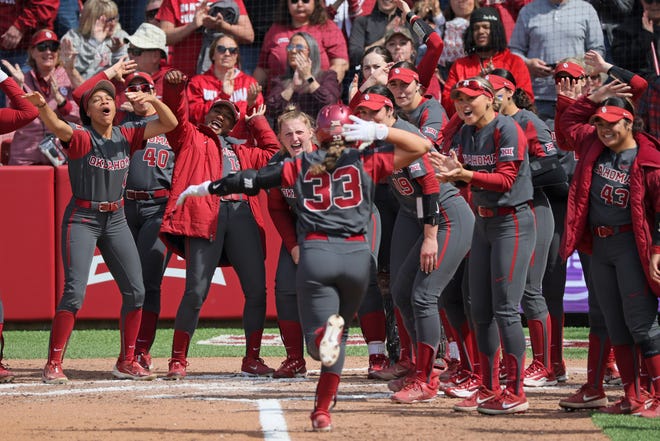 Oklahoma's Alyssa Brito (33) celebrates after hitting a home run in the third inning of a college softball game between the University of Oklahoma Sooners (OU) and the Baylor Bears in Norman, Okla., Saturday, March 23, 2024.