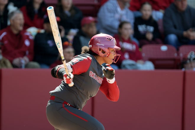 Oklahoma's Ella Parker (5) gets a base hit in the first inning of a college softball game between the University of Oklahoma Sooners (OU) and the Baylor Bears in Norman, Okla., Saturday, March 23, 2024.