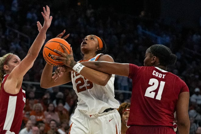 Texas Longhorns forward Aaliyah Moore (23) is fouled while shooting by Alabama forward Esence Cody (21) during the NCAA playoff game at the Moody Center on Sunday, Mar. 23, 2024 in Austin.