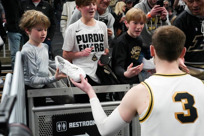 Purdue Boilermakers guard Braden Smith (3) hands a young fan hi signed shoe after the win against the Utah State Aggies on Sunday, March 24, 2024, during the second round of the NCAA Men’s Basketball Tournament at Gainbridge Fieldhouse in Indianapolis. The Purdue Boilermakers defeated the Utah State Aggies 106-67.