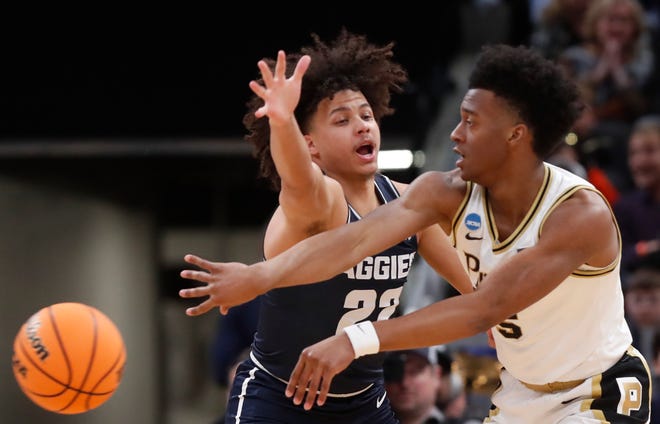 Utah State Aggies guard Javon Jackson (22) defends Purdue Boilermakers guard Myles Colvin (5) during NCAA Men’s Basketball Tournament game, Sunday, March 24, 2024, at Gainbridge Fieldhouse in Indianapolis.