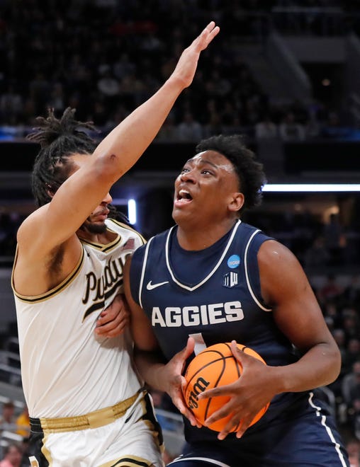 Purdue Boilermakers forward Trey Kaufman-Renn (4) guards Utah State Aggies forward Great Osobor (1) during NCAA Men’s Basketball Tournament game, Sunday, March 24, 2024, at Gainbridge Fieldhouse in Indianapolis.