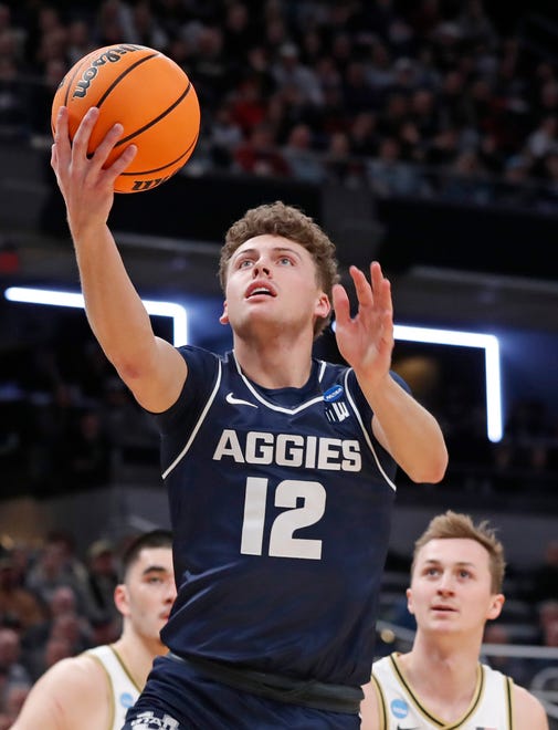 Utah State Aggies guard Mason Falslev (12) shoots the ball during NCAA Men’s Basketball Tournament game against the Purdue Boilermakers, Sunday, March 24, 2024, at Gainbridge Fieldhouse in Indianapolis.