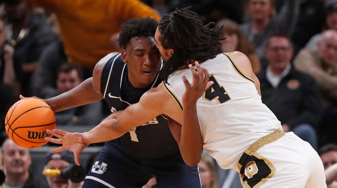 Utah State Aggies forward Great Osobor (1) is defended by Purdue Boilermakers forward Trey Kaufman-Renn (4) during NCAA Men’s Basketball Tournament game, Sunday, March 24, 2024, at Gainbridge Fieldhouse in Indianapolis. Purdue Boilermakers won 106-67.