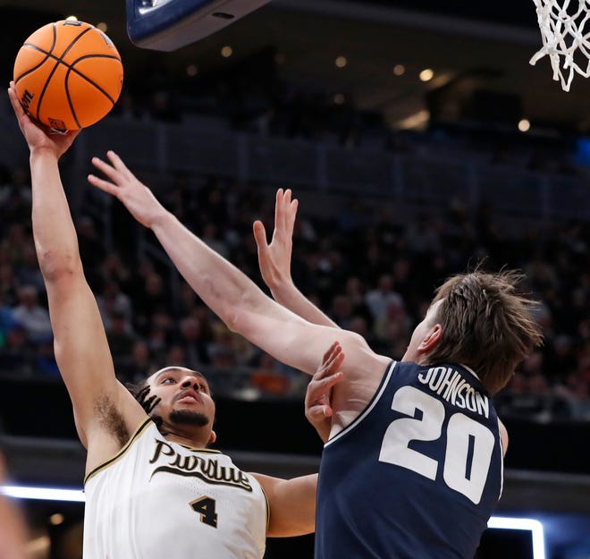 Purdue Boilermakers forward Trey Kaufman-Renn (4) shoots the ball past Utah State Aggies center Isaac Johnson (20) during NCAA Men’s Basketball Tournament game, Sunday, March 24, 2024, at Gainbridge Fieldhouse in Indianapolis. Purdue Boilermakers won 106-67.