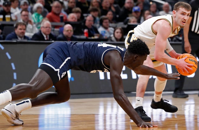 Utah State Aggies forward Kalifa Sakho (34) attempts to steal the ball from Purdue Boilermakers guard Braden Smith (3) during NCAA Men’s Basketball Tournament game, Sunday, March 24, 2024, at Gainbridge Fieldhouse in Indianapolis. Purdue Boilermakers won 106-67.