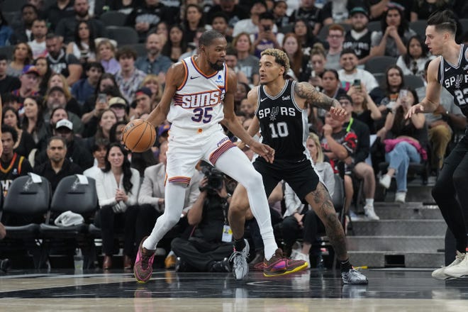 Phoenix Suns forward Kevin Durant (35) dribbles against San Antonio Spurs forward Jeremy Sochan (10) in the first half at Frost Bank Center in San Antonio on March 23, 2024.