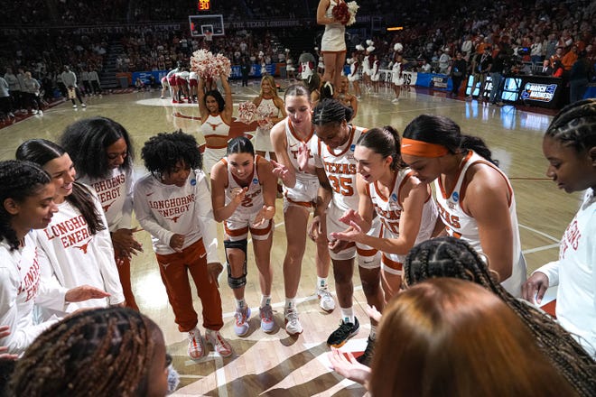 The Texas Longhorns huddle ahead of the NCAA playoff game against Alabama at the Moody Center on Sunday, Mar. 23, 2024 in Austin.