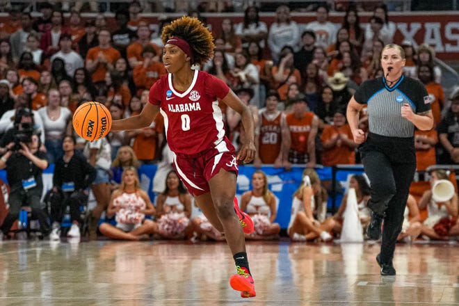 Alabama guard Loyal McQueen (0) dribbles the ball towards the Texas Longhorns basket during the NCAA playoff game at the Moody Center on Sunday, Mar. 23, 2024 in Austin.