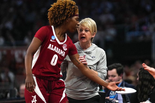 Alabama head coach Kristy Curry talks to guard Loyal McQueen (0) as she is taken out of the NCAA playoff game against the Texas Longhorns at the Moody Center on Sunday, Mar. 23, 2024 in Austin.