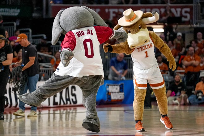 Alabama mascot Big Al and Texas Longhorns mascot HookEm meet on the court at halftime during the NCAA playoff game at the Moody Center on Sunday, Mar. 23, 2024 in Austin.