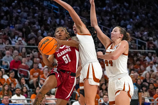 Alabama guard Del'Janea Williams (51) pushes past Texas Longhorns guard Shaylee Gonzales (2) during the NCAA playoff game at the Moody Center on Sunday, Mar. 23, 2024 in Austin.