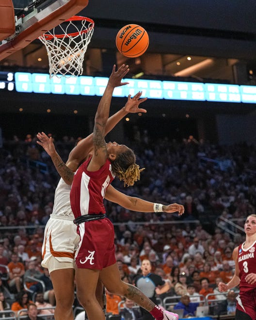Alabama guard Del'Janea Williams (51) is blocked by Texas Longhorns forward Aaliyah Moore (23) during the NCAA playoff game at the Moody Center on Sunday, Mar. 23, 2024 in Austin.
