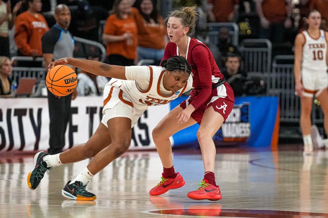 Texas Longhorns guard Madison Booker (35) pushes past Alabama guard Karly Weathers (22) during the NCAA playoff game at the Moody Center on Sunday, Mar. 23, 2024 in Austin.