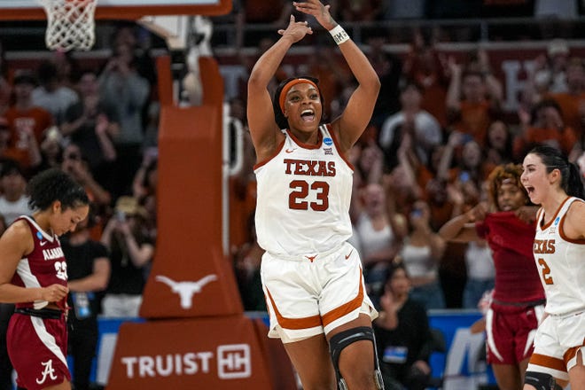 Texas Longhorns forward Aaliyah Moore (23) celebrates as time expires in the NCAA playoff game against Alabama at the Moody Center on Sunday, Mar. 23, 2024 in Austin. The Texas Longhorns defeated Alabama 65-54.