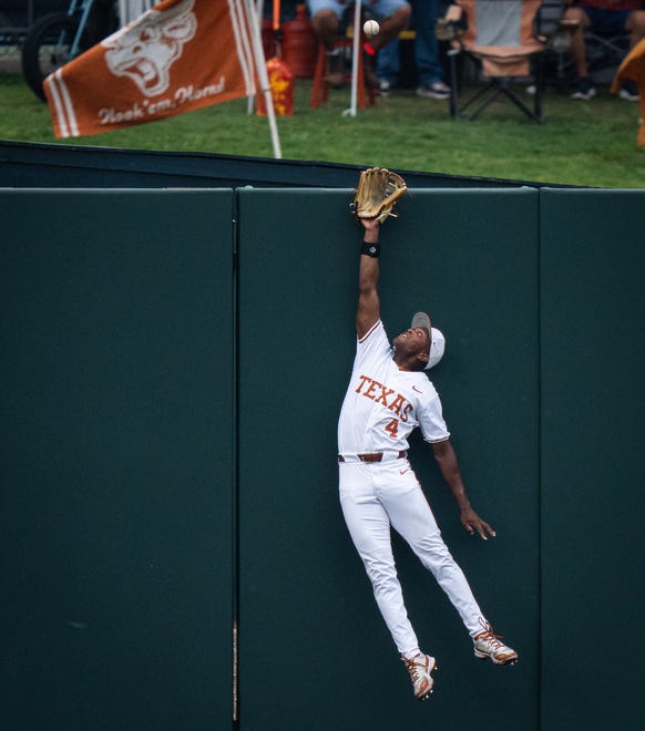 Texas Longhorns outfielder Porter Brown (4) reaches to catch a ball that would fall just over the barrier in the first inning of the LonghornsÕ game against the UTRGV Vaqueros at UFCU Disch-Falk Field, Tuesday, April 16, 2024.