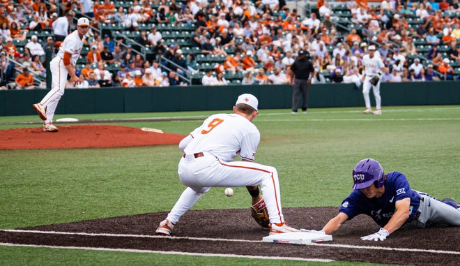 Texas Longhorns infielder Jared Thomas (9) catches the ball as TCU Horned Frogs infielder Ryder Robinson (0) slides back to the base during a pickoff attempt from Texas in the second inning of the Longhorns' game against the TCU Horned Frogs at UFCU Disch-Falk Field, Friday, April 19, 2024.