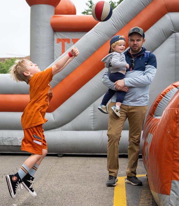 Cooper Florence, 6, plays on the inflatables on Bevo Boulevard ahead of the Texas Longhorns' spring Orange and White game at Darrell K Royal Texas Memorial Stadium in Austin, Texas, April 20, 2024.