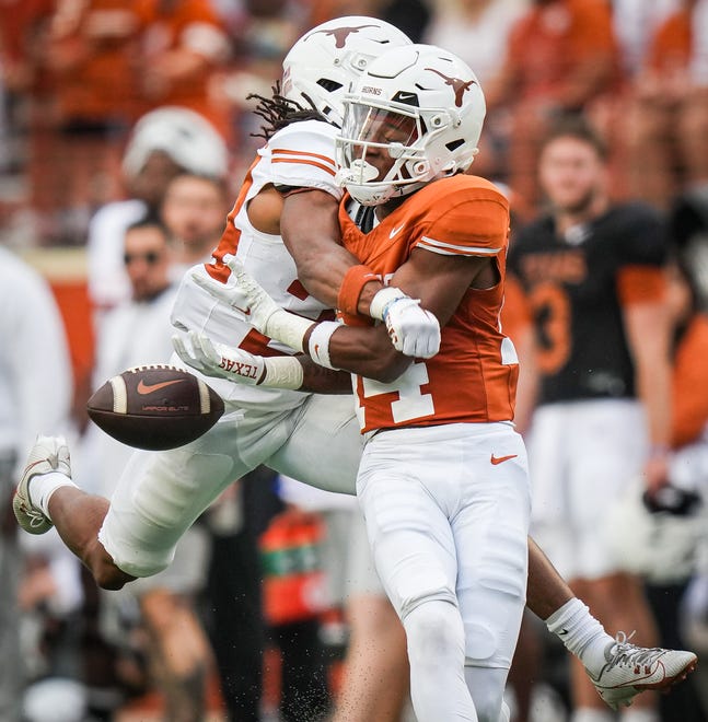 Texas White defensive back Warren Roberson (24) knocks a catch away from Texas Orange wide receiver Aaron Butler (26) during the Longhorns' third quarter of the spring Orange and White game at Darrell K Royal Texas Memorial Stadium in Austin, Texas, April 20, 2024.