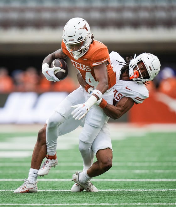 Texas White defensive back Warren Roberson (24) tackles Texas Orange wider receiver Aaron Butler (14) in the fourth quarter of the Longhorns' spring Orange and White game at Darrell K Royal Texas Memorial Stadium in Austin, Texas, April 20, 2024.
