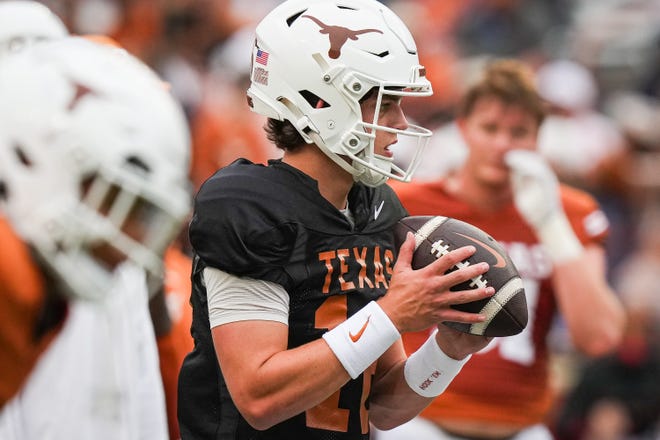 Texas Longhorns quarterback Arch Manning (16) looks for a pass while warming up ahead of the Longhorns' spring Orange and White game at Darrell K Royal Texas Memorial Stadium in Austin, Texas, April 20, 2024.