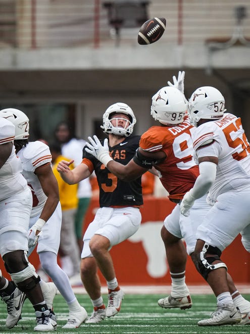 Texas Longhorns quarterback Quinn Ewers (3) watches as his pass is intercepted by Texas Orange team defensive lineman Alfred Collins (95) in the first quarter of the Longhorns' spring Orange and White game at Darrell K Royal Texas Memorial Stadium in Austin, Texas, April 20, 2024.